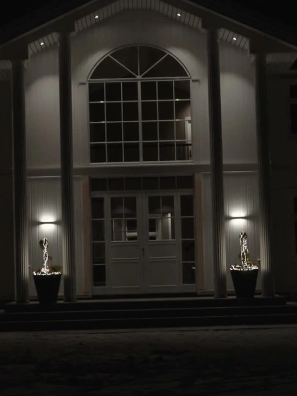 House with its facade lighting on in the evening